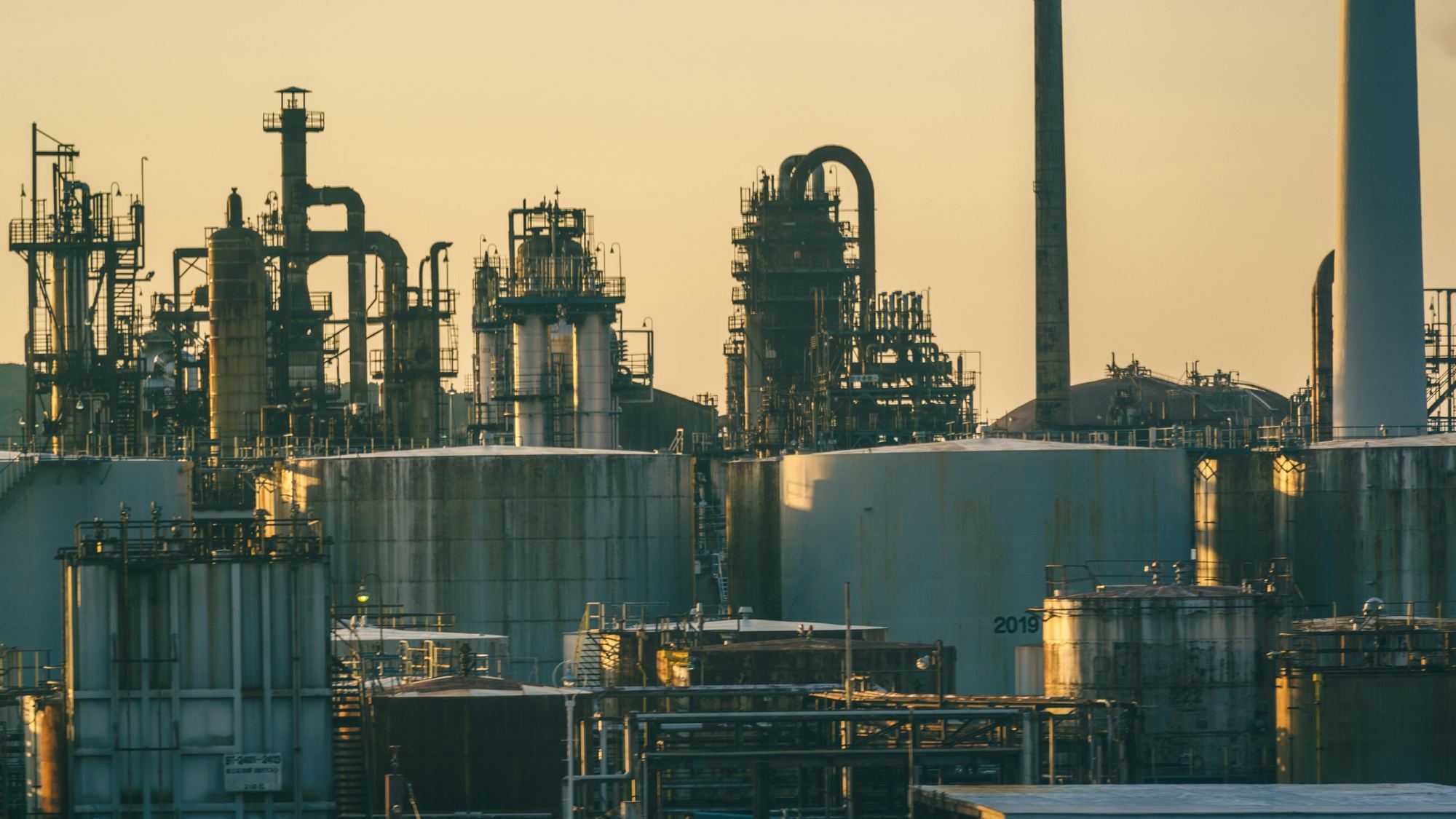 Refinery towers and storage tanks at dusk
